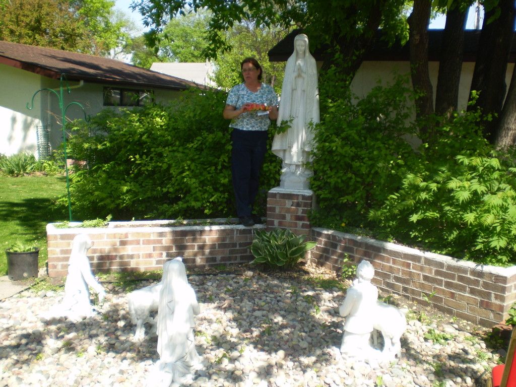 Shelly from activities crowns Mary in our Fatima grotto.